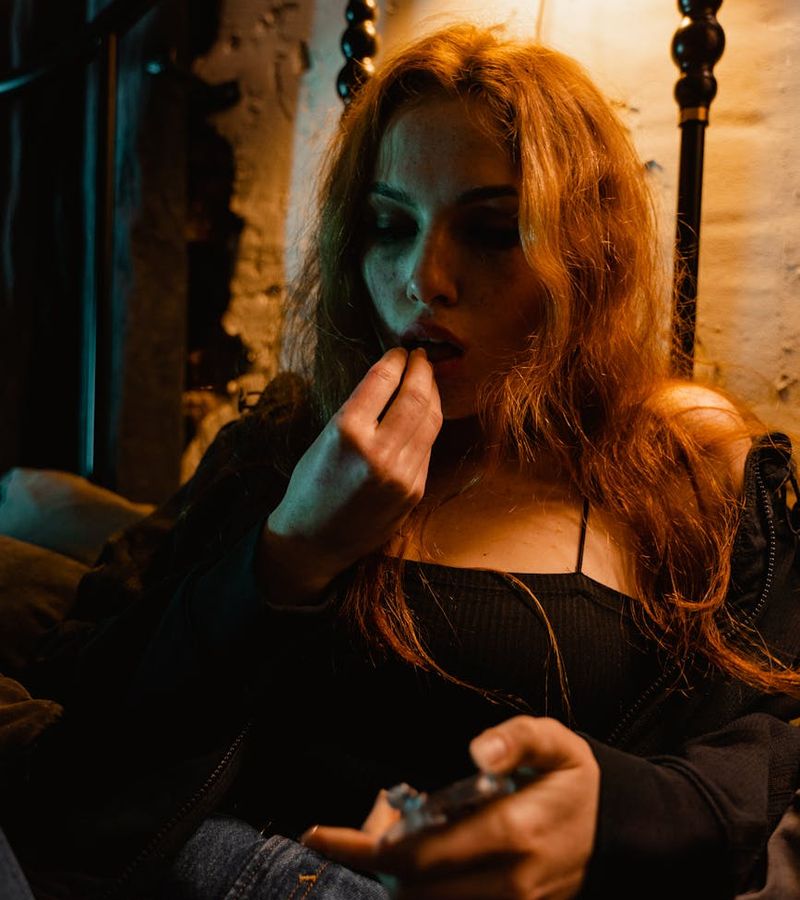 Person meditating peacefully in a dimly lit room with a calm atmosphere.